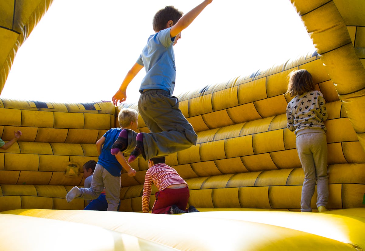 Classic Bounce House — children playing on a brightly colored inflatable castle